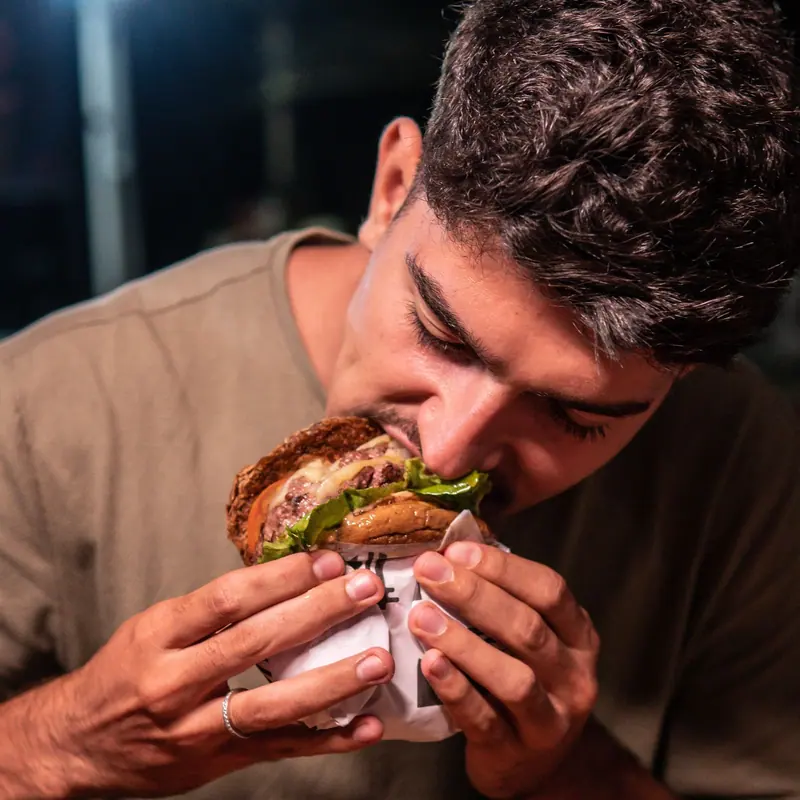 Biting into a loaded burger